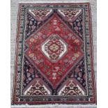 Property of a lady - a Persian Abadeh hand knotted wool rug, with navy ground, 61 by 42ins. (155