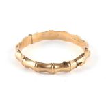 Property of a lady - a 9ct gold faux bamboo hinged bangle, safety chain missing, approximately 14.