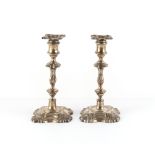 Property of a deceased estate - a pair of Edwardian silver candlesticks in the George II style,