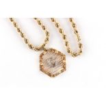Property of a gentleman - a 14ct yellow gold hexagonal pendant centred by a white metal (probably
