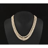 Property of a lady - a pearl three strand necklace, the 290 pearls ranging from approximately 2.98mm