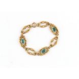 Property of a lady - an unmarked yellow gold (tests 14ct) link bracelet set with three oval cut