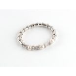 An 18ct white gold pearl & diamond torc bangle, the three pearls each approximately 8.7mm