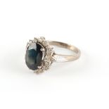 Property of a deceased estate - a platinum sapphire & diamond cluster ring, the oval cut sapphire