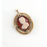 A 19th century unmarked yellow gold & enamel oval framed carved shell cameo pendant depicting a