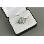 An unmarked platinum or white gold zircon & diamond ring, the oval cut zircon weighing approximately