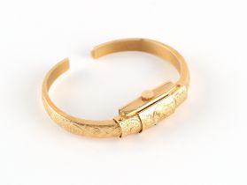 Property of a deceased estate - a lady's Swiss 18ct yellow gold bracelet watch of torc bangle form