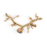 Property of a lady - a 14ct yellow gold charm bracelet with eight 9ct gold charms (the horse seal