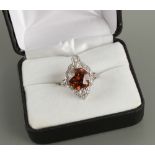An unusual Art Deco style unmarked platinum or white gold brown zircon & diamond cluster ring, the