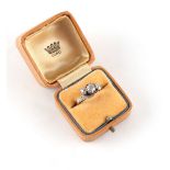 Property of a lady - an 18ct yellow gold diamond three stone ring with crossover mount, with further