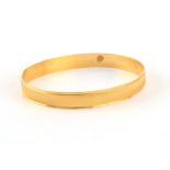 Property of a lady - a Turkish 22ct yellow gold bangle, with milled decoration, approximately 17.5