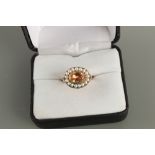 An unmarked 19th century gold topaz & seed pearl ring, the oval cut topaz weighing approximately 1.