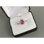 An unmarked white gold pink tourmaline & diamond pear shaped cluster ring, the pear shaped cut