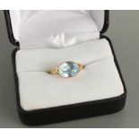 A late Georgian unmarked yellow gold aquamarine ring, the oval cut aquamarine weighing approximately