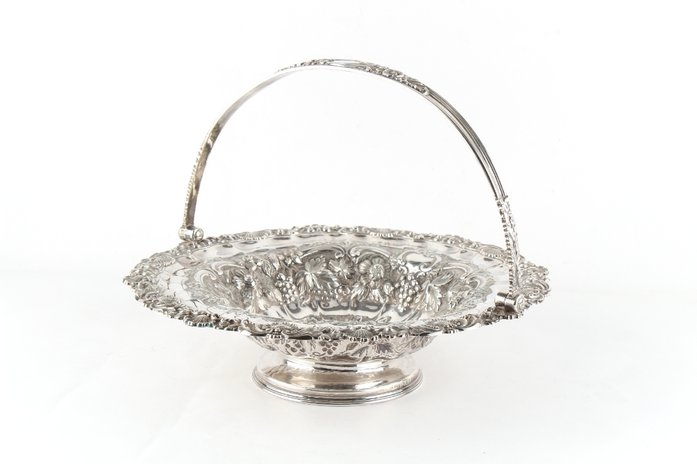 Property of a deceased estate - a George IV silver circular pedestal cake basket with swing