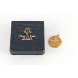 Property of a gentleman - a 9ct gold St. Christopher pendant, 27mm diameter, approximately 7.8