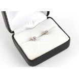 A pair of 18ct white gold diamond stud earrings, the two round brilliant cut diamonds weighing