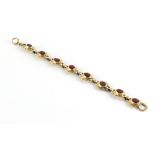 A 19th century silver gilt & garnet link bracelet, with eight oval cut garnets in oval flowerhead