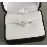 An 18ct white gold diamond flowerhead cluster ring, the seven round brilliant cut diamonds
