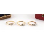 Property of a gentleman - two 18ct yellow gold diamond three stone rings, both boxed; together