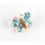 An 18ct yellow gold blue topaz & citrine butterfly brooch, the two larger pear shaped cut blue topaz