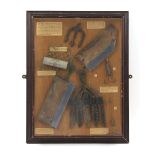 A wall display case containing antique & vintage river fishing and poaching implements, the case