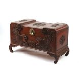 Property of a deceased estate - a Chinese carved camphorwood trunk, 43.3ins. (110cms.) wide (