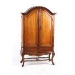 Property of a lady - a late 18th century Dutch carved walnut arched two door cabinet, with fielded