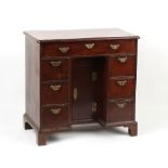 Property of a lady - an 18th century George II/III mahogany kneehole desk, of small proportions,