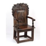 Property of a lady - a carved oak caqueteuse type armchair, parts 17th century.