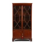 Property of a lady - a reproduction mahogany bookcase with tracery glazed doors above two-door