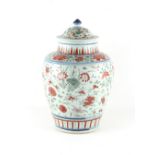 A Chinese wucai baluster jar, late 17th century, decorated with floral sprays, with associated