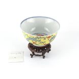 Property of a lady - a Chinese yellow sgraffito ground dragon bowl, underglaze blue Qianlong seal