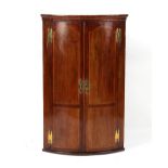 Property of a deceased estate - a mid 18th century mahogany & strung bow-fronted two-door corner