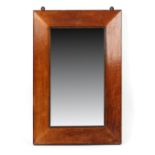 Property of a deceased estate - a maple veneered rectangular framed wall mirror, the frame mid