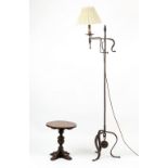 Property of a lady - a wrought iron standard lamp; together with a small oak circular topped