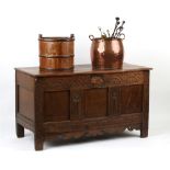 Property of a lady - a 17th century carved oak coffer with 19th century elm top, 49.25ins. (125cms.)