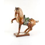 Property of a gentleman - a Chinese sancai glazed pottery model of a prancing horse, Tang Dynasty (