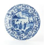 A Chinese blue & white plate, Kangxi period (1662-1722), painted with figures in a garden with a