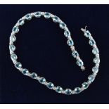 A good 18ct white gold pale blue topaz & diamond riviere necklace, possibly Asprey, with twenty-nine