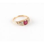 An 18ct yellow gold ruby & diamond ring, the cushion cut ruby weighing approximately 1.06 carats,