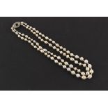 A natural saltwater pearl two strand necklace, the largest barrel shaped pearl measuring