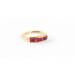 Property of a deceased estate - a 22ct yellow gold ruby ring, set with a row of five square cut