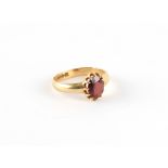 A gent's 18ct yellow gold garnet ring, the oval cut garnet in claw setting, approximately 4.9 grams,