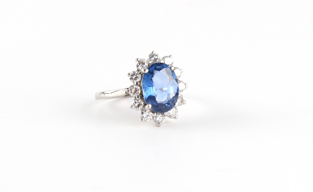 An unmarked white gold sapphire & diamond oval cluster ring, the oval cushion cut sapphire - Image 2 of 2