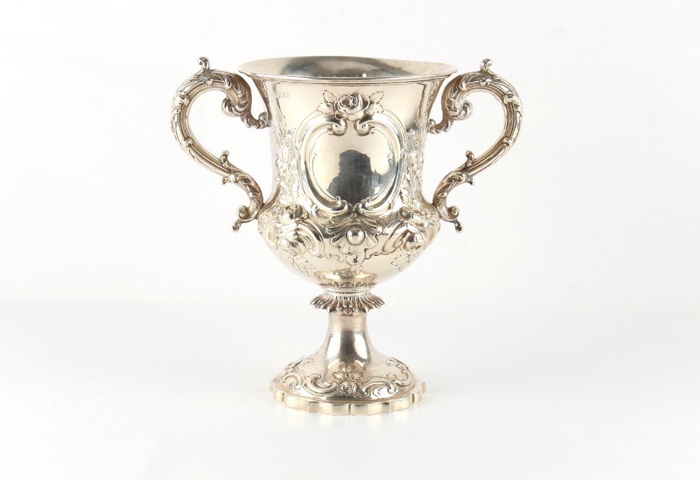 Property of a gentleman - a Victorian silver two handled pedestal cup, with repousse floral & 'C'-