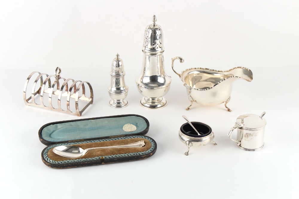 Property of a gentleman - a mixed lot of silver including a sauceboat, two casters, a toast rack,