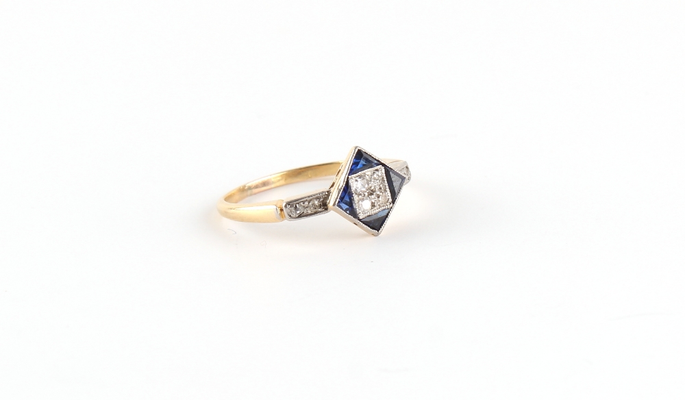 An Art Deco yellow unmarked gold sapphire & diamond ring, the diamond shaped millegrain setting with
