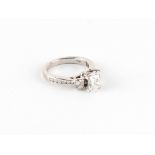 A good 18ct white gold diamond three stone ring, the centre certificated princess cut diamond