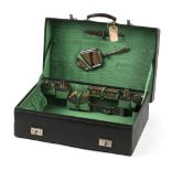 Property of a deceased estate - an early 20th century green leather dressing case containing eight